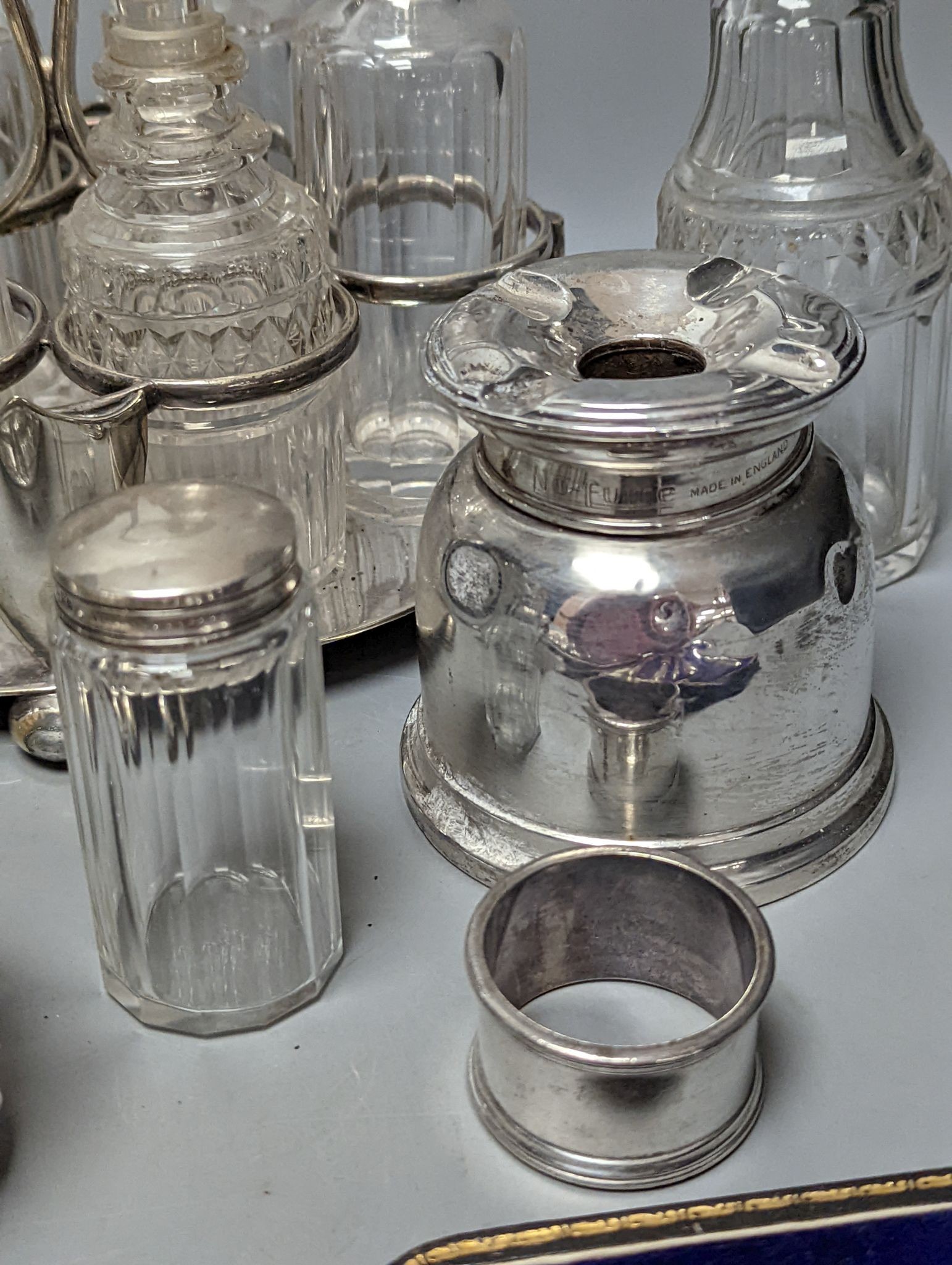 A plated cruet stand, two cased sets of silver handled tea knives, a silver domed ashtray(a.f.) silver trophy cup, four silver mounted glass jars and a plated napkin ring.